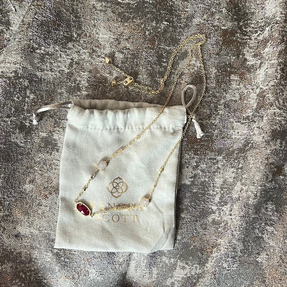 Gold Kendra Scott adjustable necklace. Iridescent Drusy & burgundy stone.